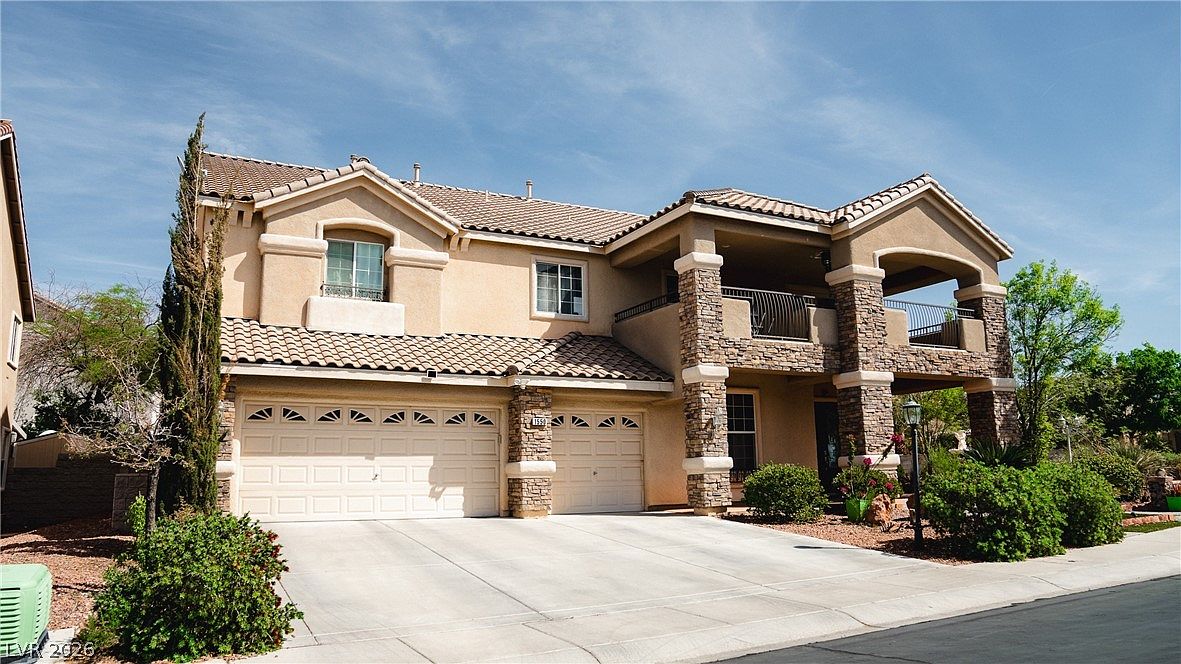 Tight three-quarter view of 1550 Via Cassia, the stone columns and arched second-story balcony filling the frame